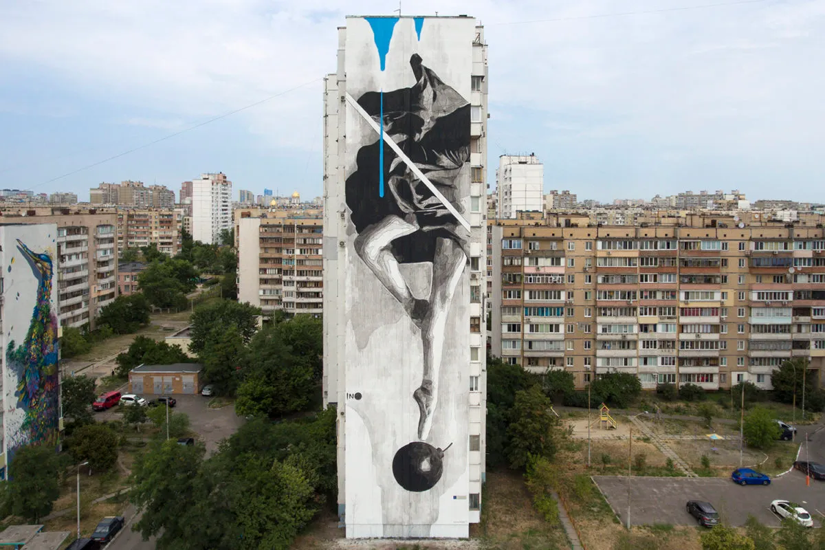 Mural by INO in Kyiv, Ukraine, 2016. Reaching 158 feet above the ground, the Greek artist completed the biggest mural that he had ever made to that point. INO’s artwork, titled “Instability,” depicts a ballerina dancing over a bomb. Inspired by the situation in Ukraine, the painting is criticizing the failure of coexistence between people on earth.